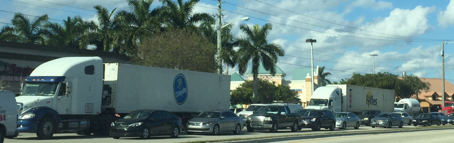 Trucks waiting at a busy intersection to access a nearby freight facility